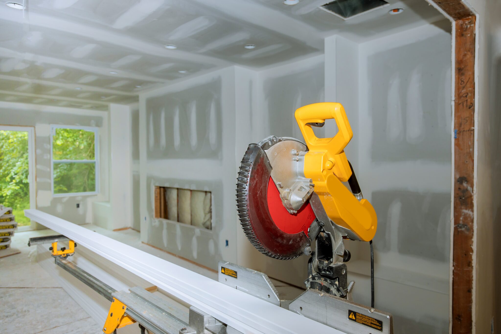 Circular saw cutting wooden base molding new home installing construction building industry remodel